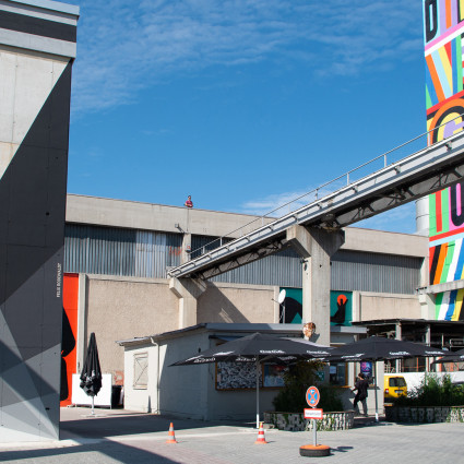 The former factory buildings are now adorned with colourful designs.