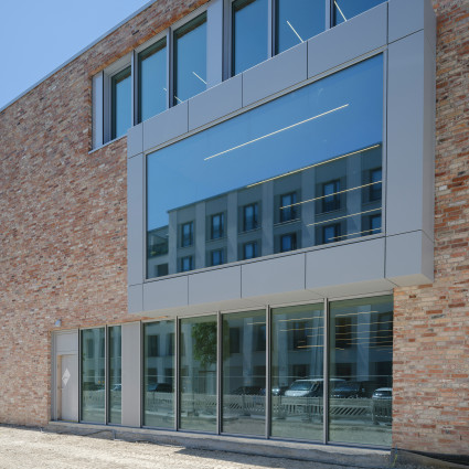Facade of the Neue Ziegelei (New Brickworks) on Maria-Nindl-Platz, which opened in 2025 as a community and cultural centre.